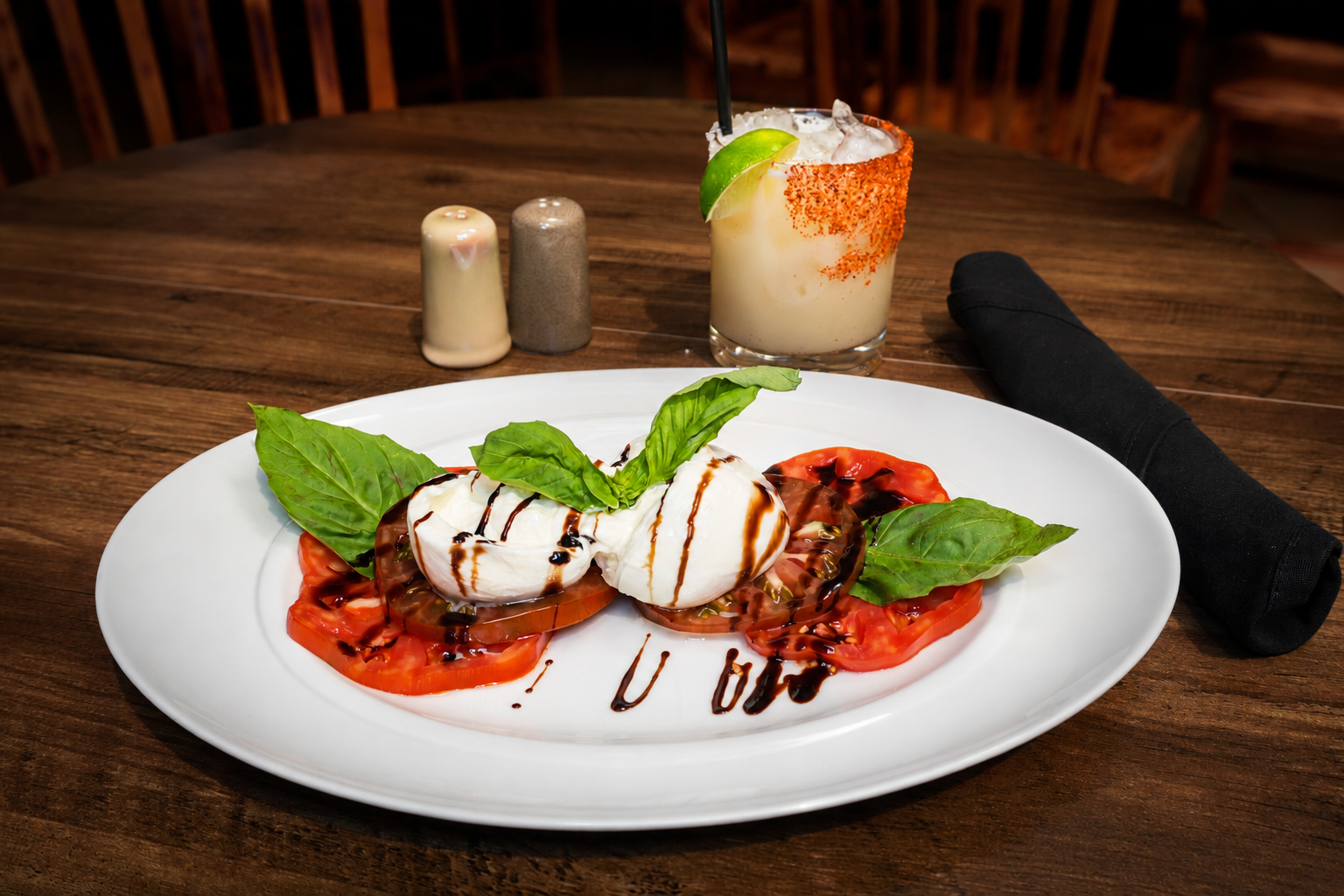 Caprese salad with a chili-rimmed cocktail