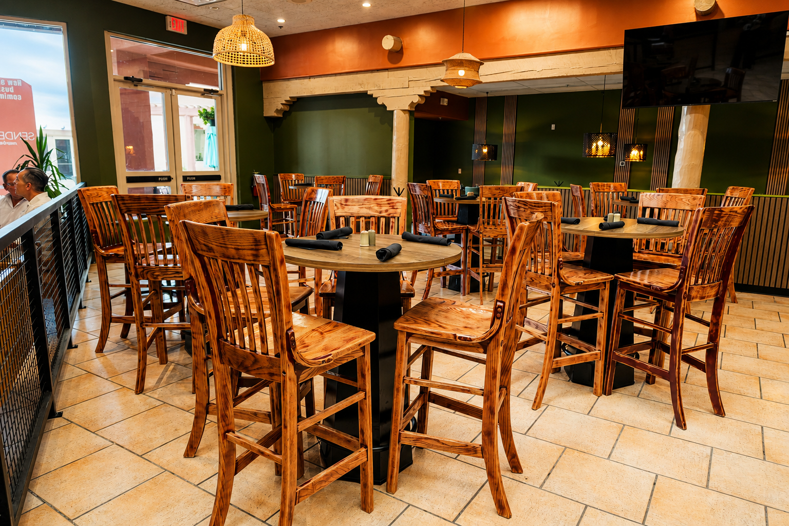 High wooden chairs and round tables in the dining room