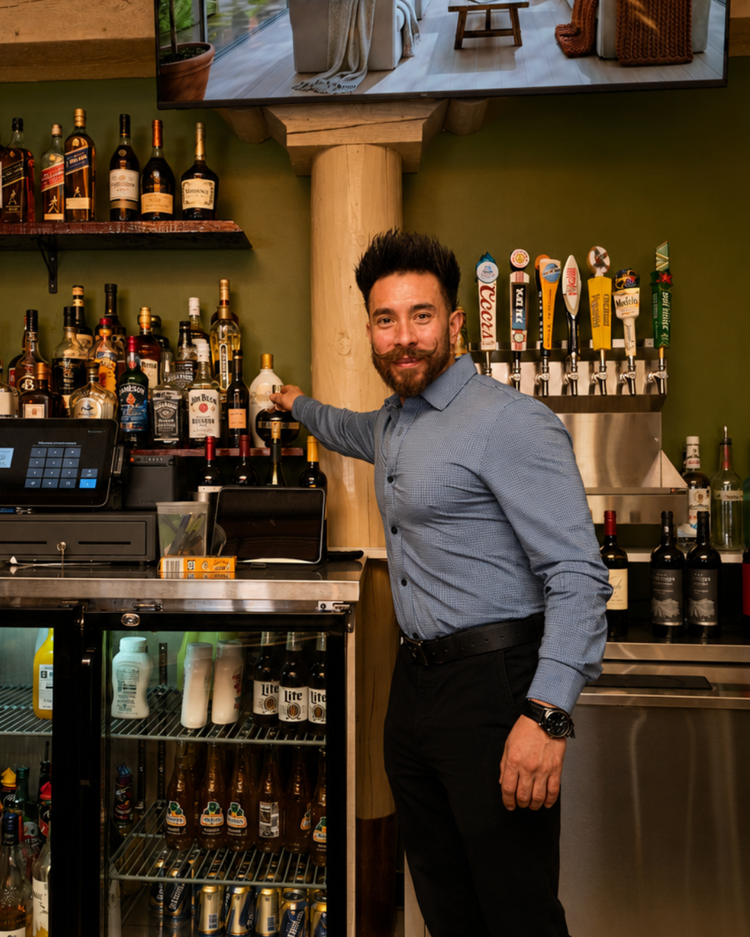 One of our hosts smiling behind the bar